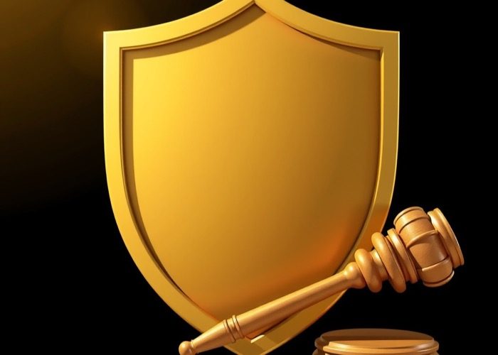 Golden shield and gavel on black